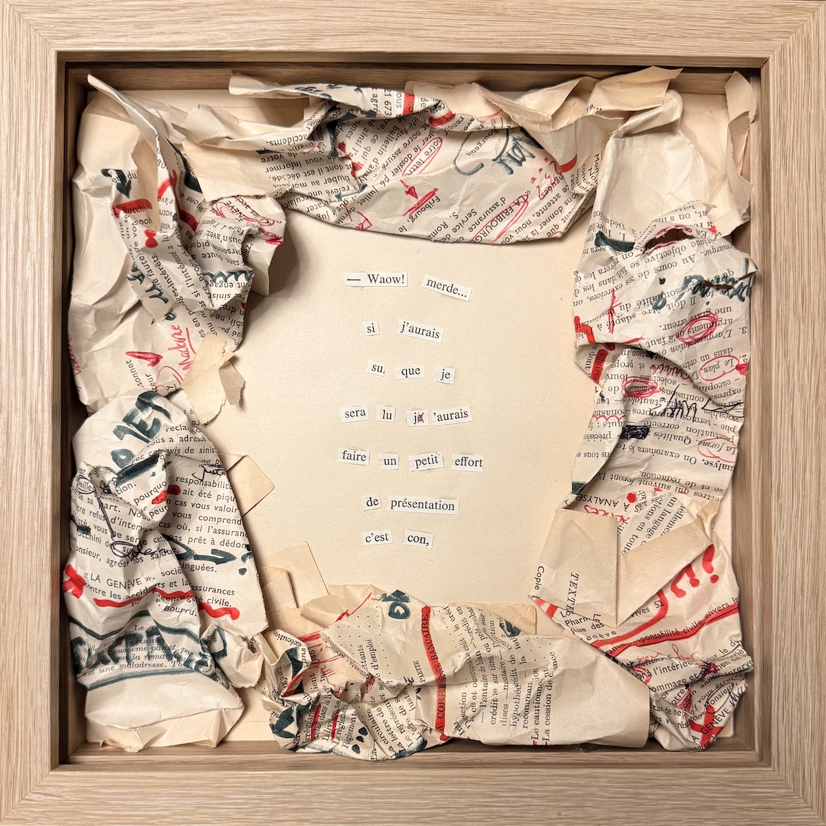 Collage textuel composé de fragments de phrases disposés au centre, entourés de pages imprimées froissées et annotées en rouge, encadré dans un caisson en bois clair.
